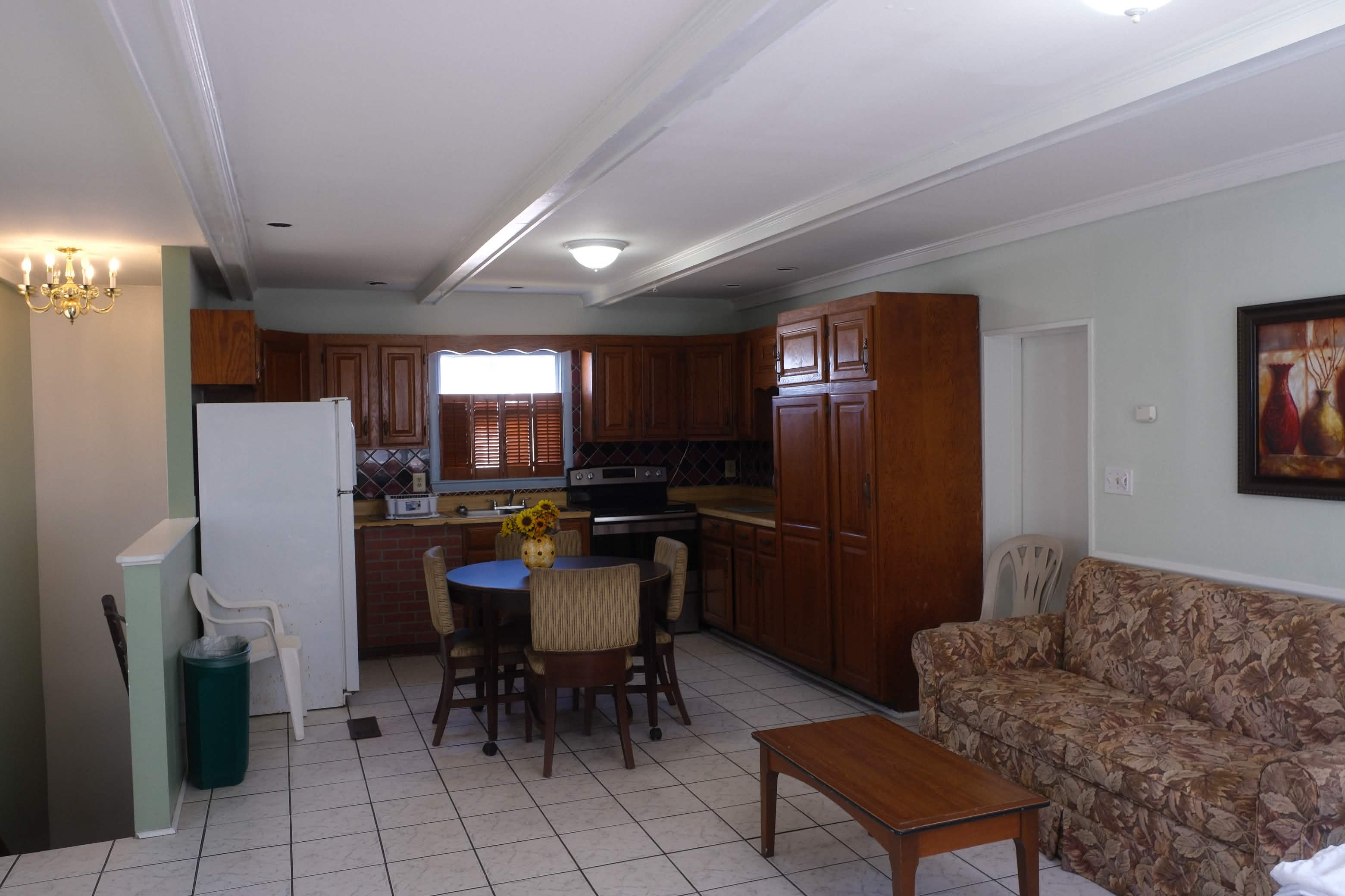 Bedroom with sofa and beamed ceiling